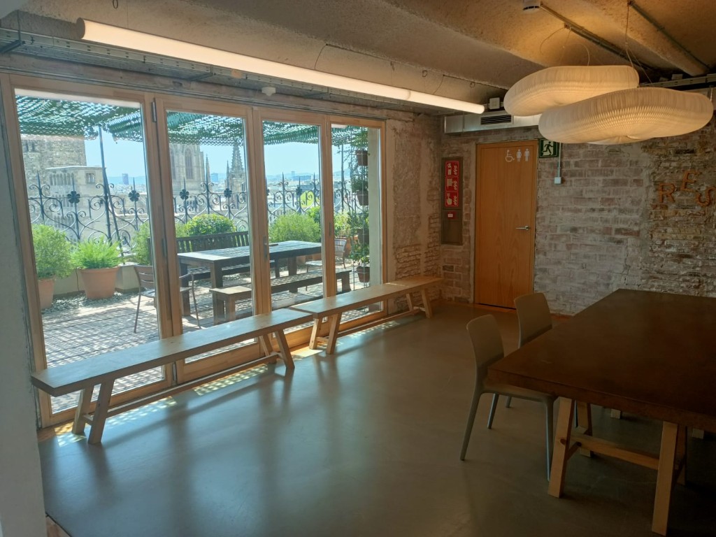 Indoor space at Pier07 opening onto the terrace through large glass doors